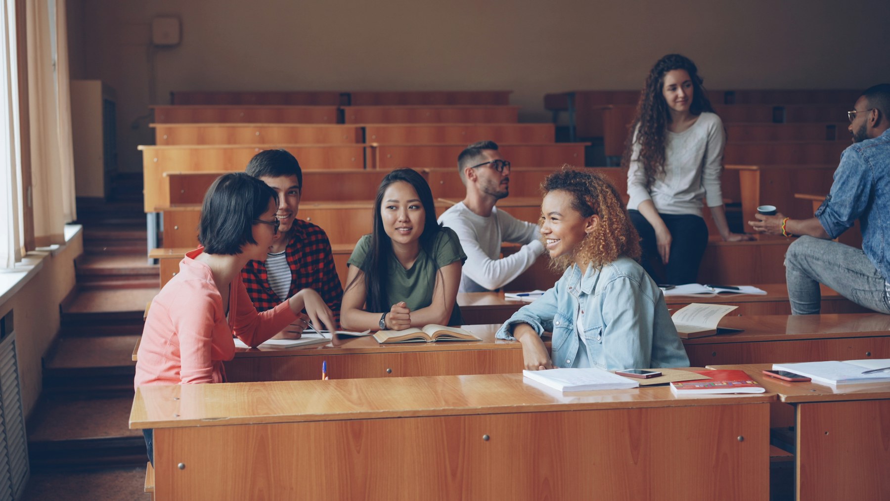 Students talking together in a lecture hall